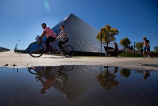 Long Beach, CA., March 11, 2020 - Students past by The Walter Pyramid at Cal State Long Beach, where the campus has gone to online only classes on Tuesday, March 11, 2020 in Long Beach, California. (Jason Armond / Los Angeles Times)