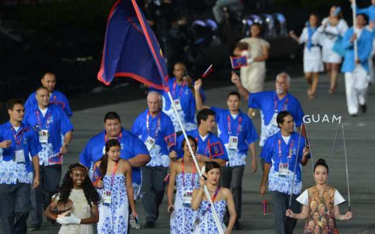 Guam's team enters Olympic Stadium during the opening ceremony.