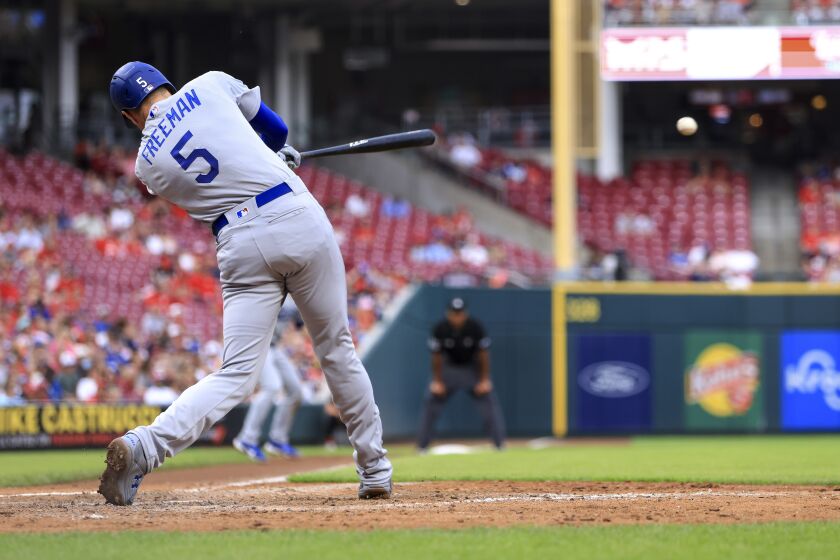 Los Angeles Dodgers' Freddie Freeman hits an RBI single against the Cincinnati Reds during the fifth inning of a baseball game in Cincinnati, Wednesday, June 22, 2022. (AP Photo/Aaron Doster)