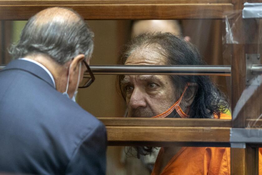 Adult film star Ron Jeremy talks with his attorney Stuart Goldfarb during his arraignment on rape and sexual assault charges at Clara Shortridge Foltz Criminal Justice Center, Friday, June 26, 2020, in Los Angeles. Jeremy pleaded not guilty to charges of raping three women and sexually assaulting a fourth. (David McNew/Pool Photo via AP)