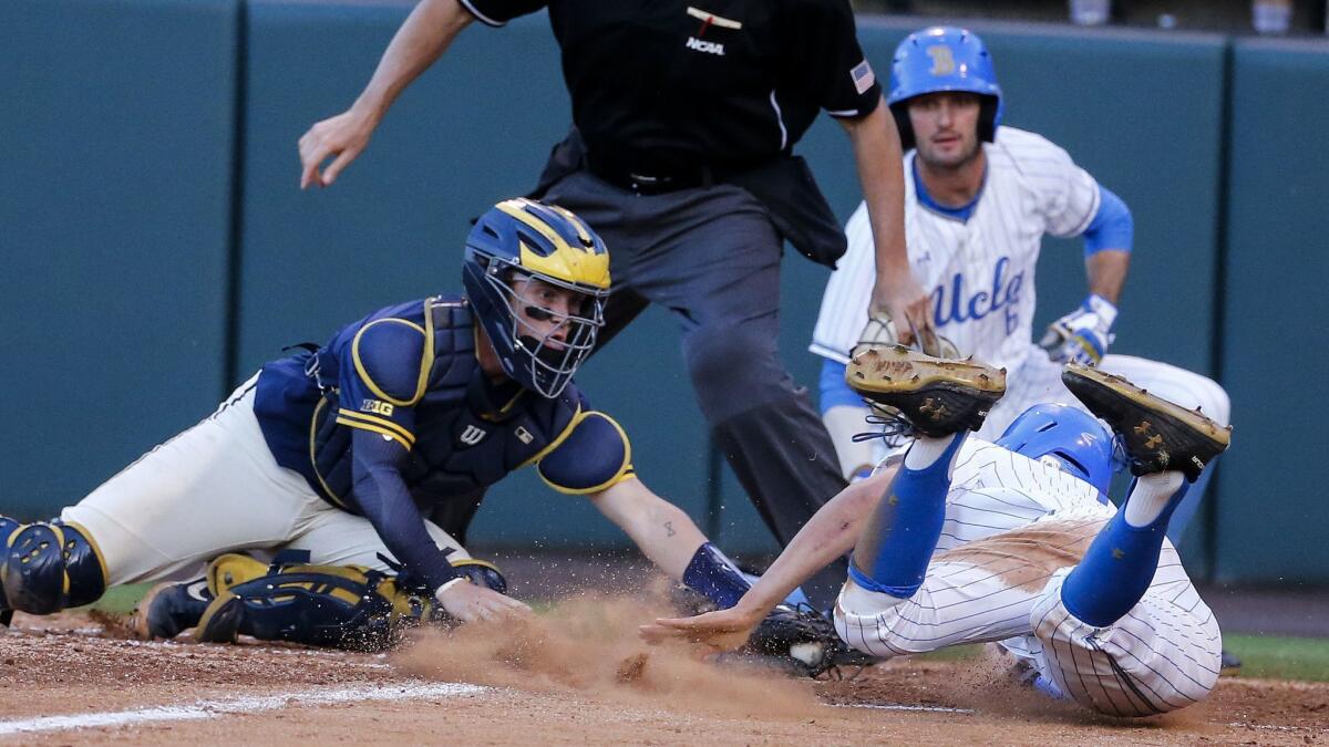 Michigan catcher Joe Donovan tags out UCLA's Jeremy Ydens during the fourth inning June 9.