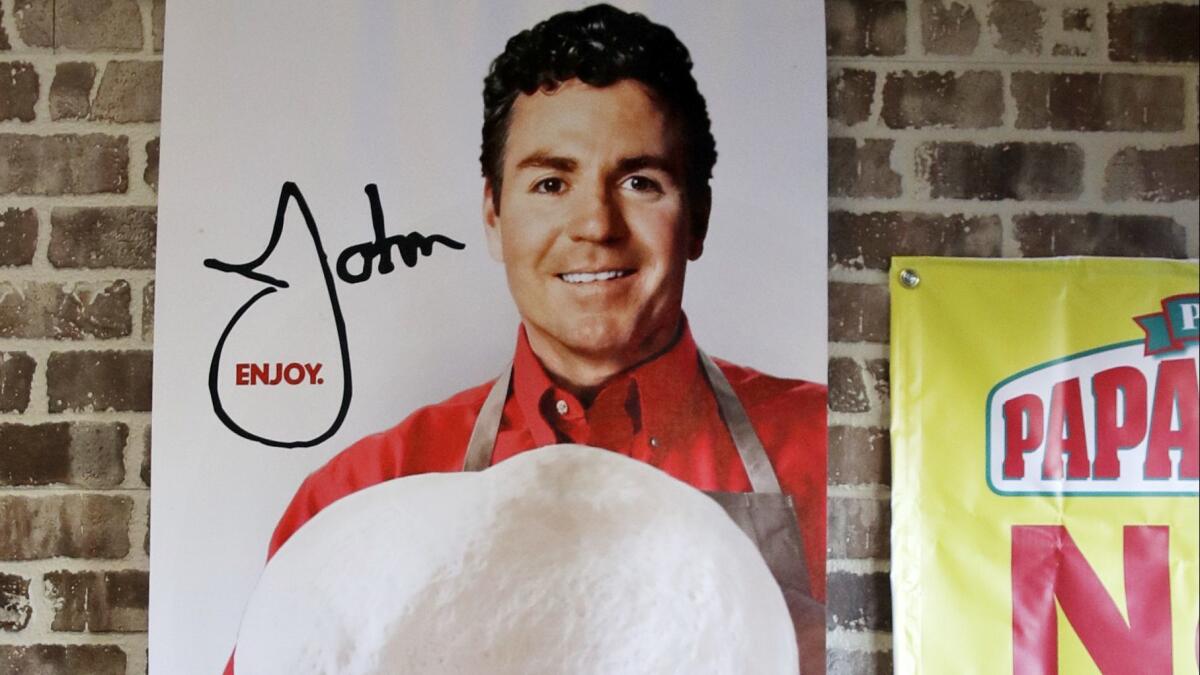 A sign featuring Papa John's founder John Schnatter hangs at a Papa John's pizza store in 2017. Schnatter's image has since been removed from marketing materials.