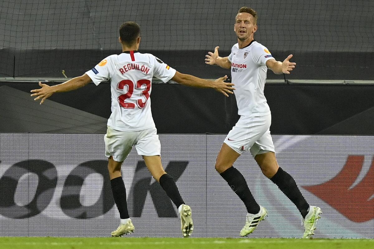 Sevilla's Luuk de Jong, right, celebrates with his teammate Sergio Reguilon after he scored.