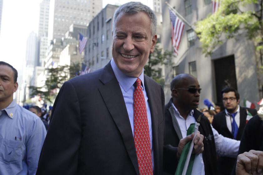 FILE - New York City Mayor Bill de Blasio winks at someone during the Columbus Day Parade in New York, Monday, Oct. 12, 2015. The former New York City Mayor says he will run for Congress in a redrawn district that includes his Brooklyn home. De Blasio announced Friday, May 20, 2022 on MSNBC’s “Morning Joe” that he will seek the Democratic nomination for the 10th Congressional District. (AP Photo/Seth Wenig, File)