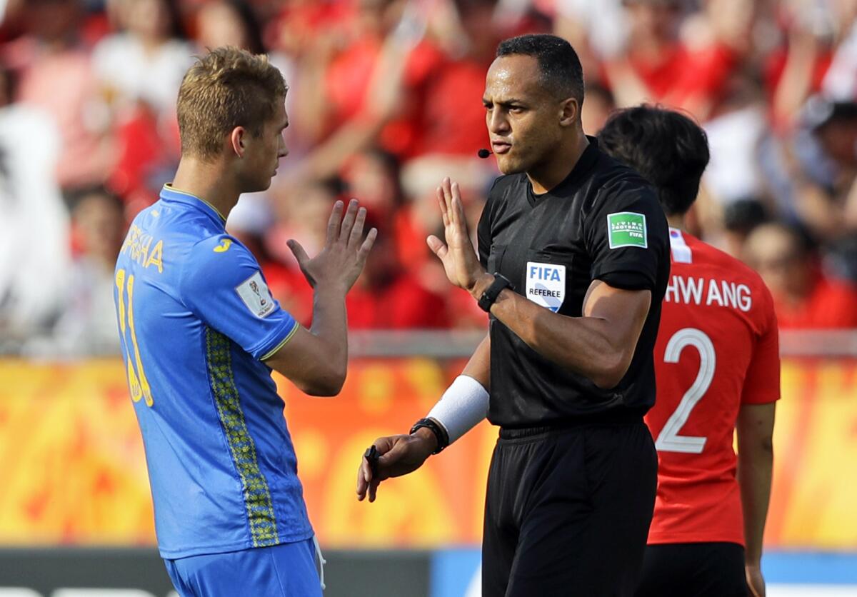 FILE - Referee Ismail Elfath gestures to Ukraine's Vladyslav Supriaha during the final match between Ukraine and South Korea at the under-20 World Cup soccer tournament in Lodz, Poland, on June 15, 2019. Elfath is the lone American among 36 referees selected by FIFA on Thursday, May 19, 2022, for this year’s World Cup. (AP Photo/Sergei Grits, File)