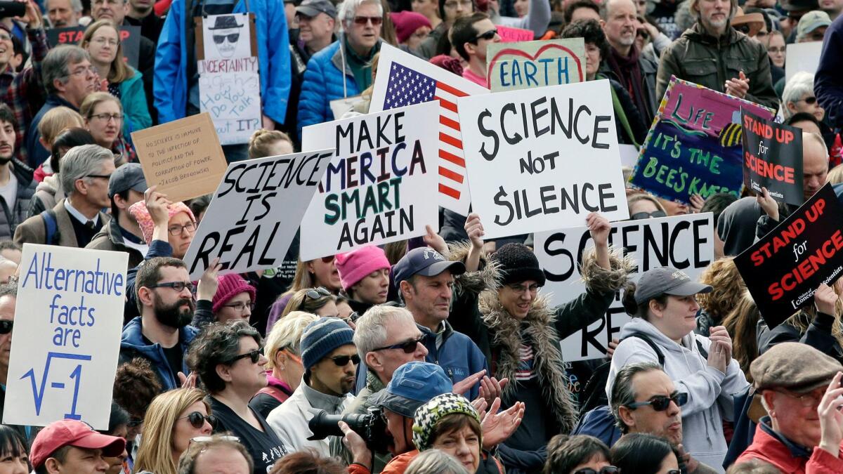 Members of the scientific community, environmental advocates and supporters demonstrate Sunday, Feb. 19, 2017, in Boston to call attention to what they say are the increasing threats to science and scientific research.