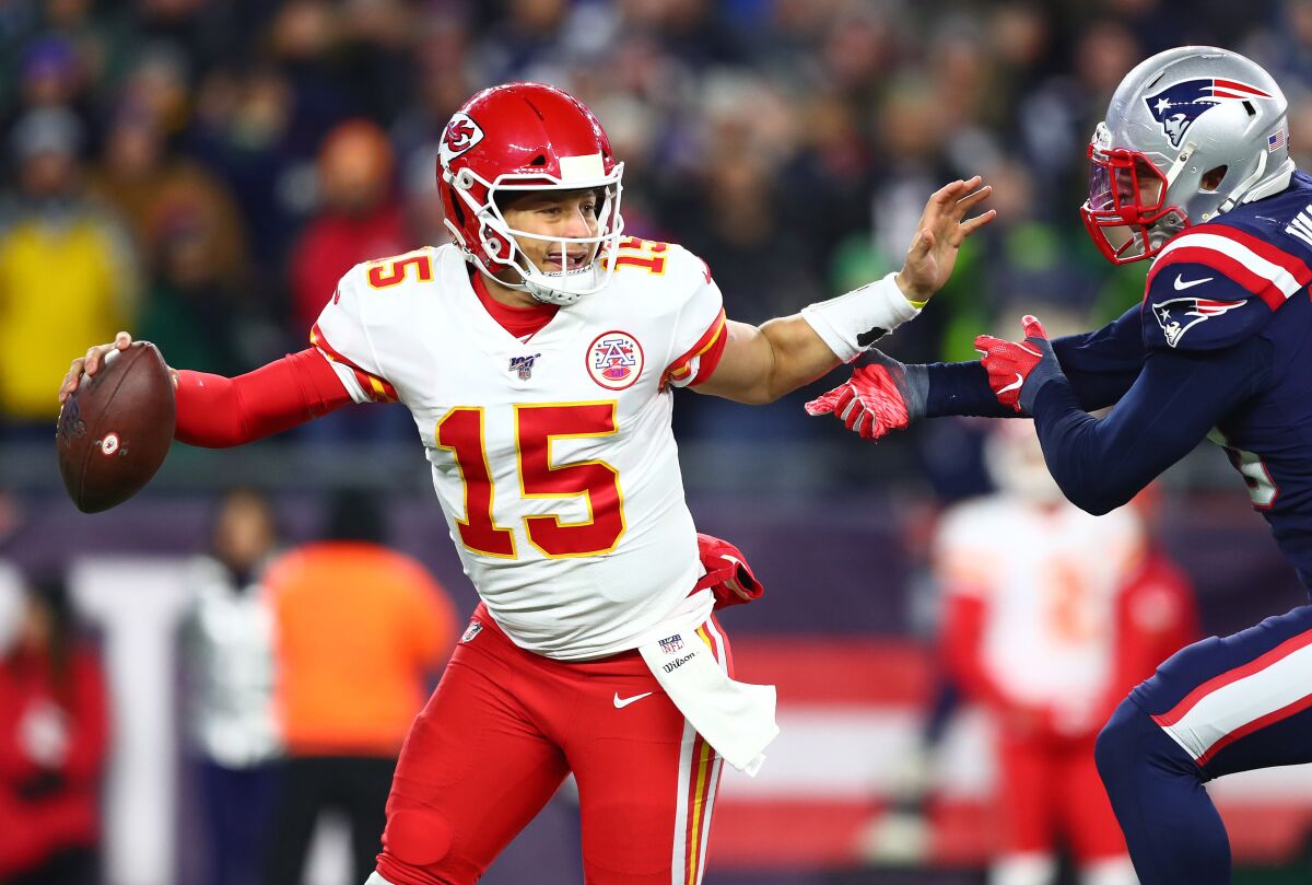 Kansas City Chiefs quarterback Patrick Mahomes is pressured by New England Patriots linebacker Kyle Van Noy