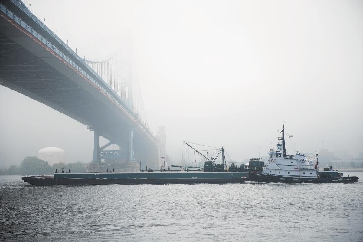 A tugboat pushes a barge on the Delaware River in Philadelphia. Researchers found intersex fish in the Delaware, Ohio and Susquehanna river basins, suggesting the presence of chemical contaminants.