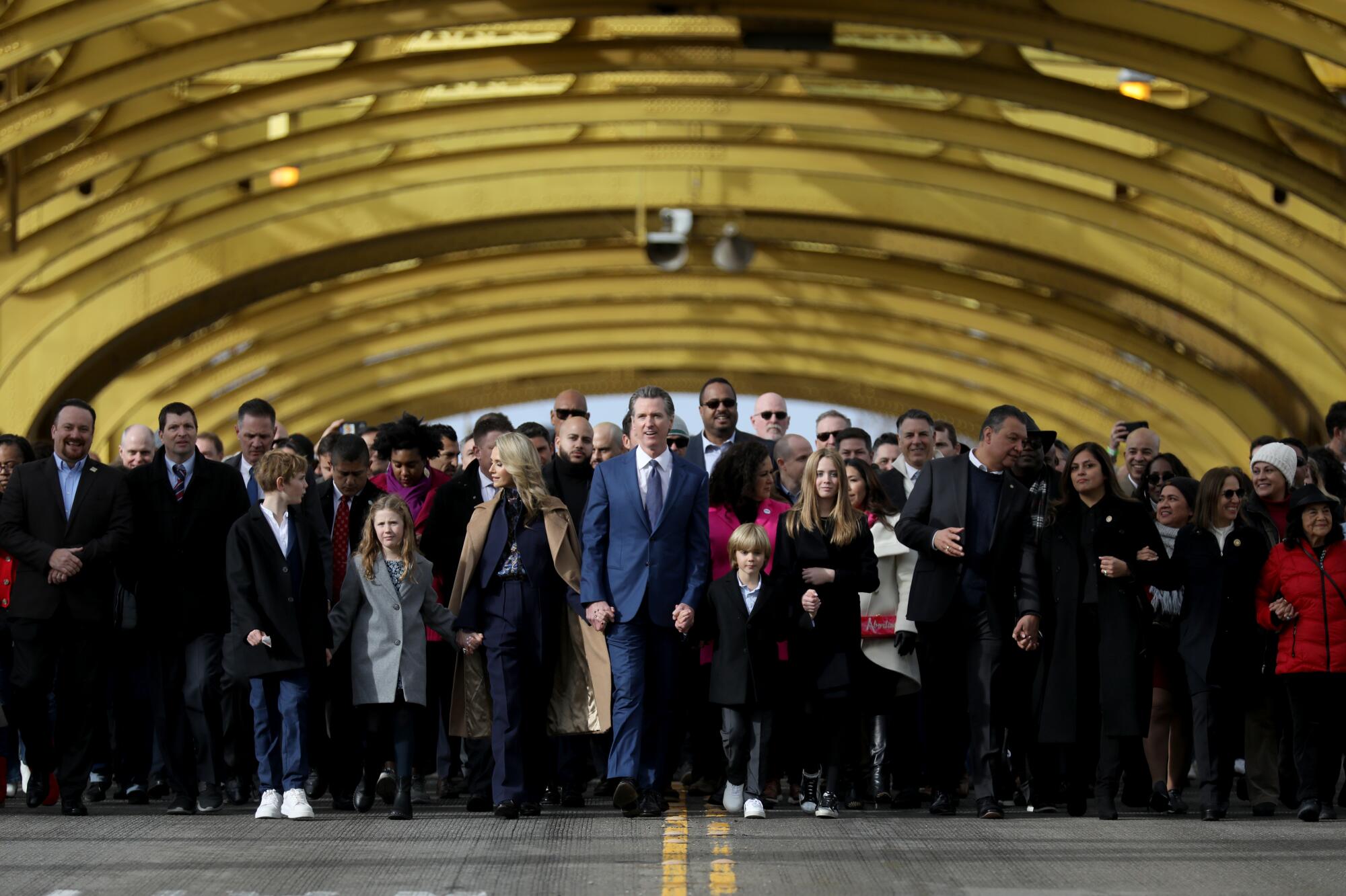 Gov. Gavin Newsom joins the People's March on Tower Bridge during his inauguration ceremony for a second term.