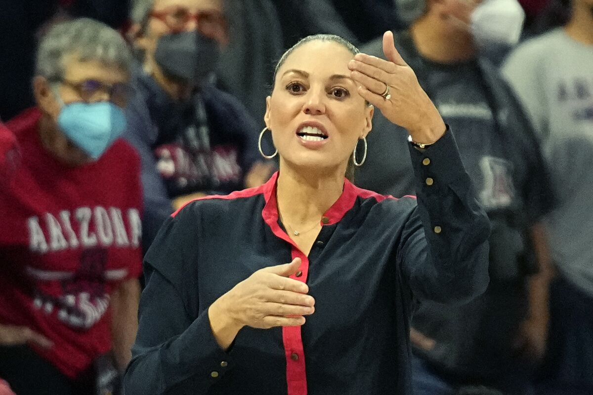 FILE - Arizona head coach Adia Barnes directs her team during the first half of an NCAA college basketball game against Washington State, on Jan. 7, 2022, in Tucson, Ariz. Barnes' feathery touch has reconstructed her alma mater from the rubble at the bottom of the Pac-12 to a national powerhouse. (AP Photo/Rick Scuteri, File)