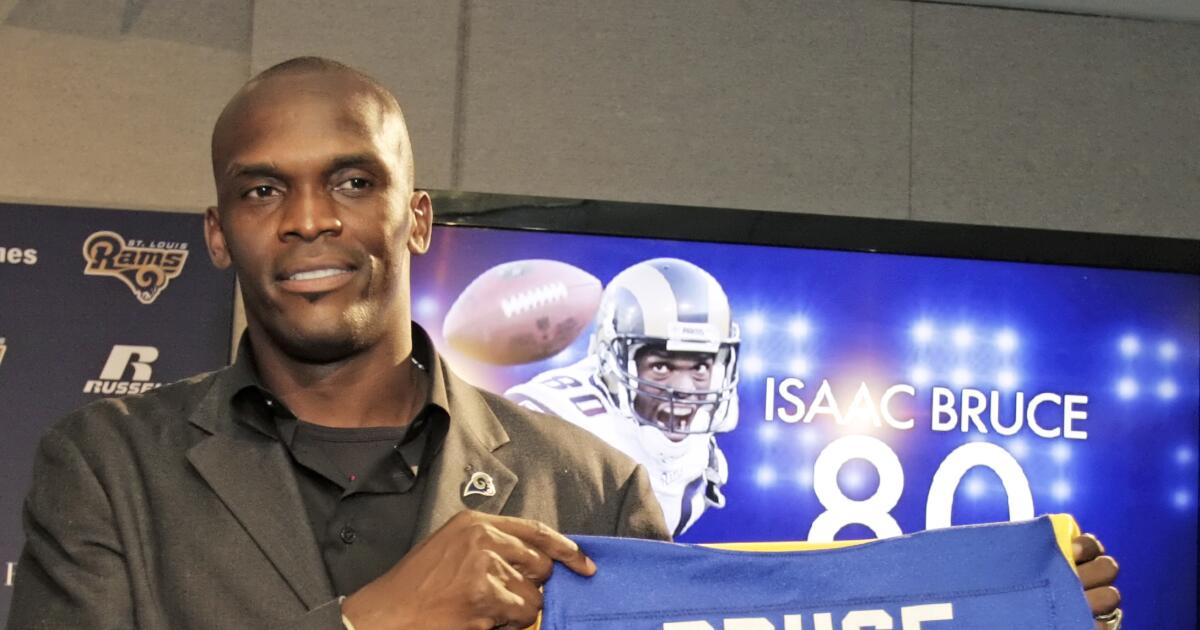 Former St. Louis Rams Isaac Bruce holds the Super Bowl trophy