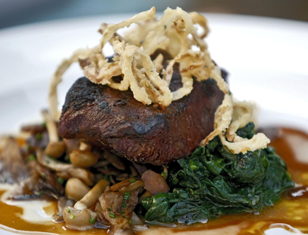 The Charbroiled flat-iron steak with wild mushrooms and organic spinach with garlic confit semi gloss at the Little Beast Restaurant in Eagle Rock on Thursday, Oct. 17, 2013.