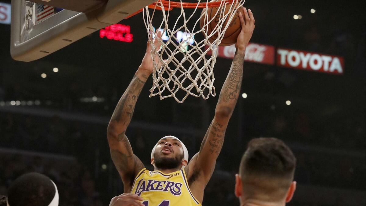 Lakers forward Brandon Ingram scores a basket against the Philadelphia 76ers in the first quarter on Tuesday at Staples Center.