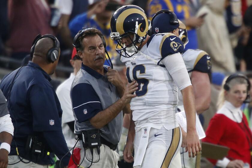 Rams Coach Jeff Fisher checks quarterback Jared Goff, who had just run for a touchdown in the fourth quarter.