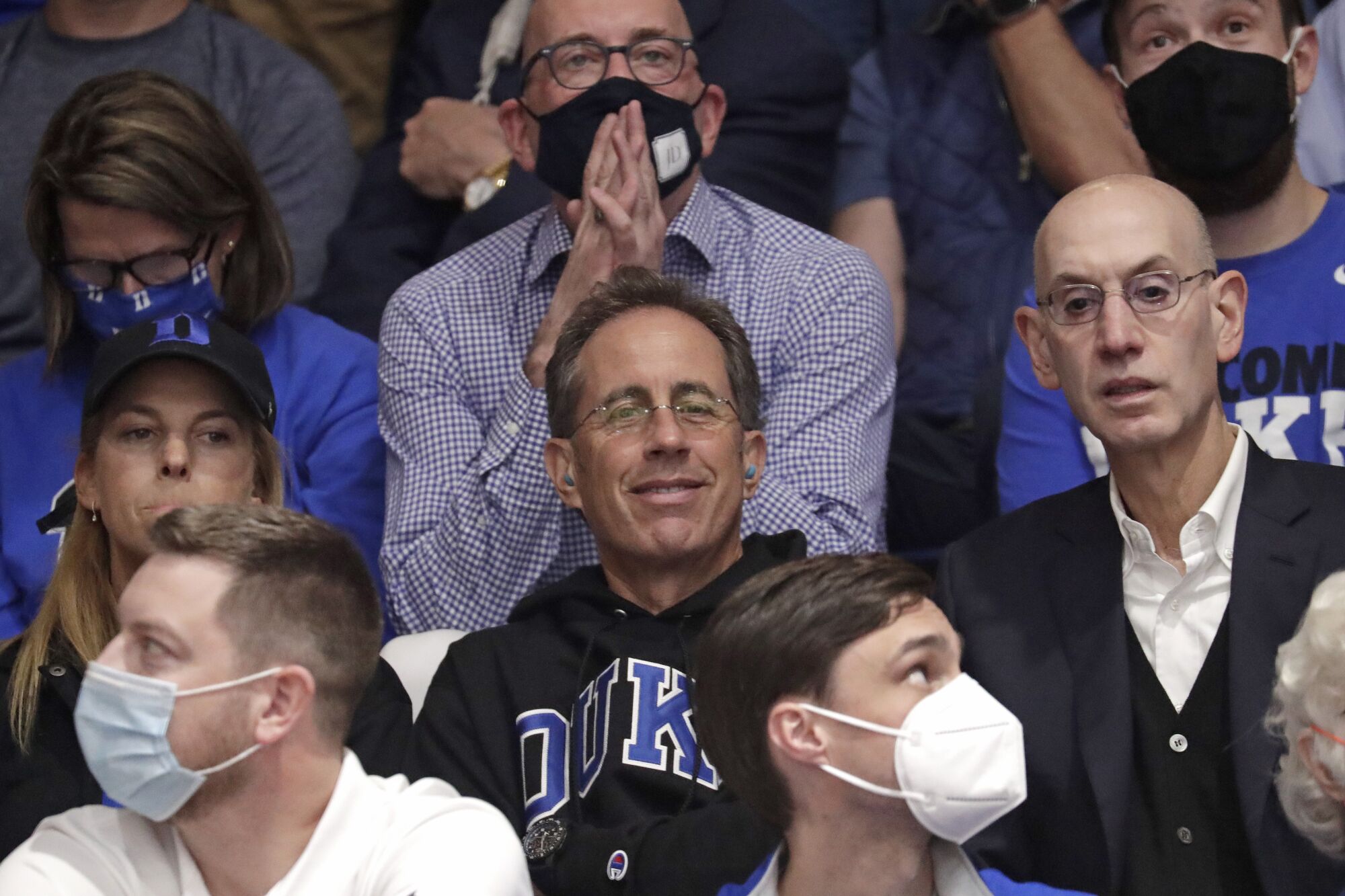 Actor and comedian Jerry Seinfeld sits next to NBA Commissioner Adam Silver.