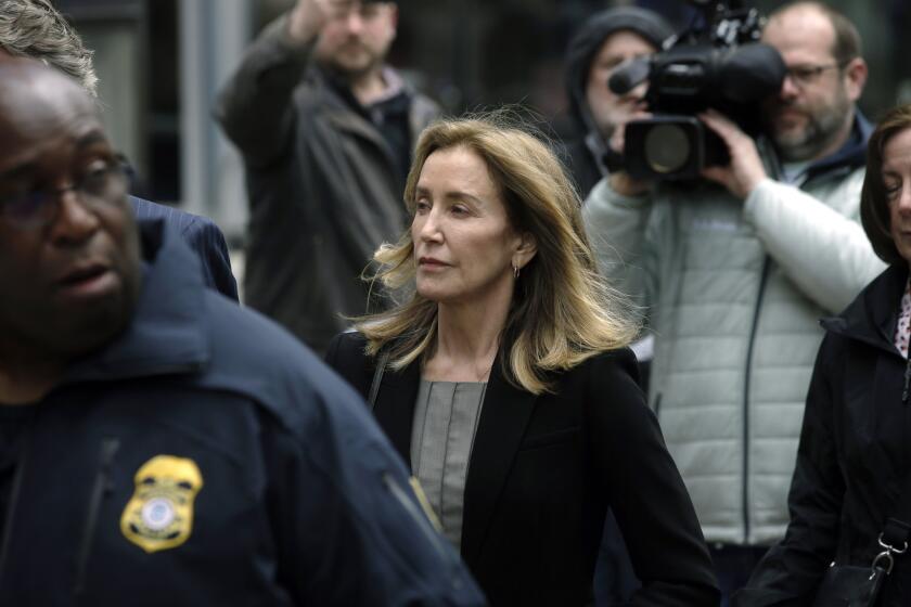 Felicity Huffman arrives at federal court Monday, May 13, 2019, in Boston, where she is scheduled to plead guilty to charges in a nationwide college admissions bribery scandal. (AP Photo/Steven Senne)