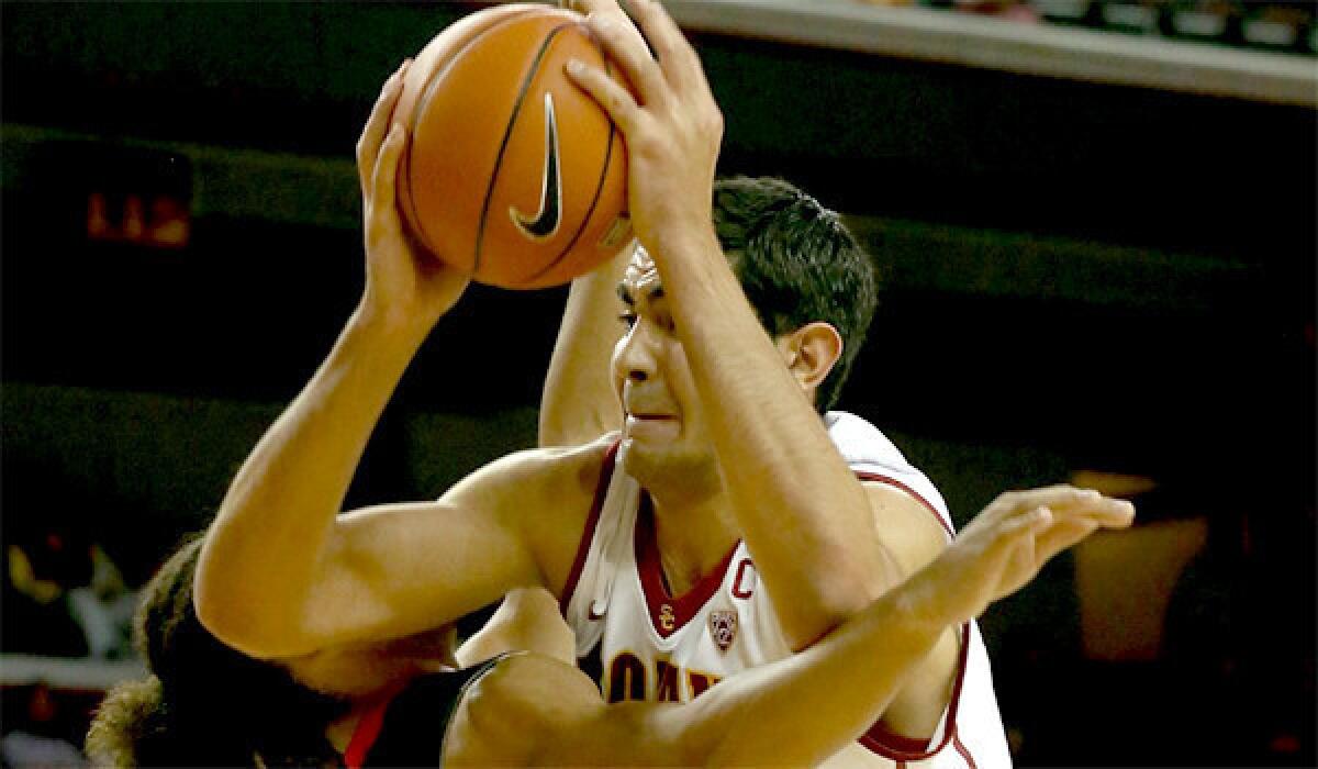 USC center Omar Oraby battles for position under the basket against Cal State Northridge center Tre Hale-Edmerson during the Trojans' 95-79 win over the Matadors on Tuesday at the Galen Center.