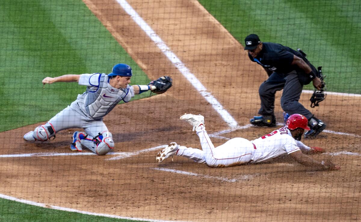 Dodgers catcher Will Smith tags out the Angels' Luis Rengio at home in a game on June 21 at Angel Stadium.