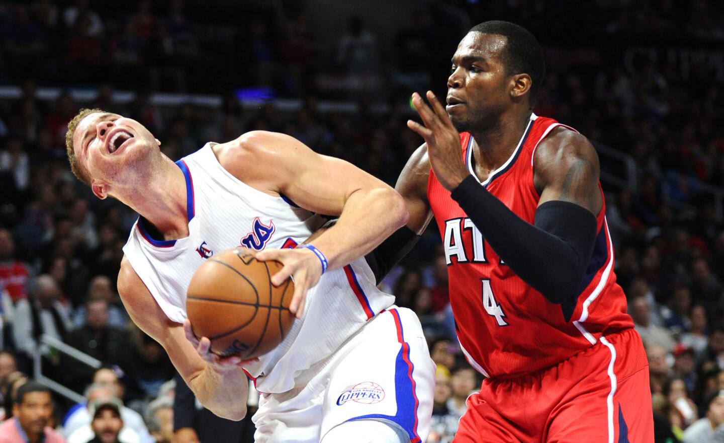 Clippers forward Blake Griffin is fouled by Hawks forward Paul Millsap while trying to score Monday night.