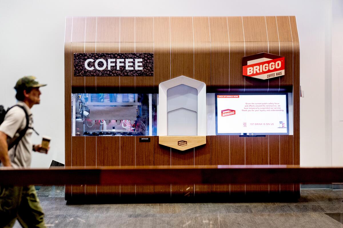 A traveler passes a Briggo coffee vending machine at San Francisco International Airport.