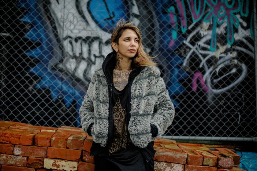 LYTTELTON, CANTERBURY REGION -- FRIDAY, SEPTEMBER 6, 2019: Laylita “Bonnie” Singh, tattoo artist and single mom who saw her coworker die in the 2011 Christchurch earthquake, and then, after recovering from being hit by brick, came together with two colleagues to form the area’s only women-owned tattoo parlor, as she poses for a portrait in Lyttelton, New Zealand, on Sept. 6, 2019. (Marcus Yam / Los Angeles Times)