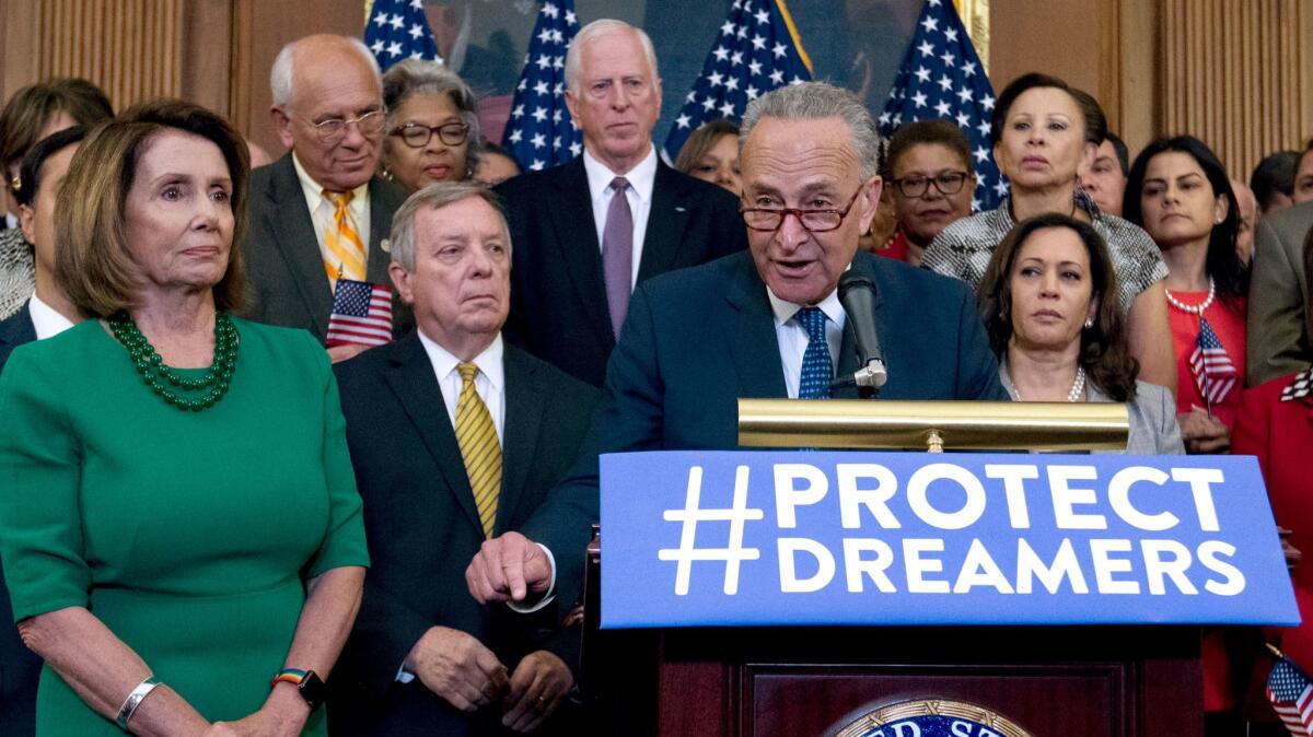 Senate Minority Leader Charles E. Schumer speaks, accompanied by House Minority Leader Nancy Pelosi and other congressional Democrats, on Sept. 6.