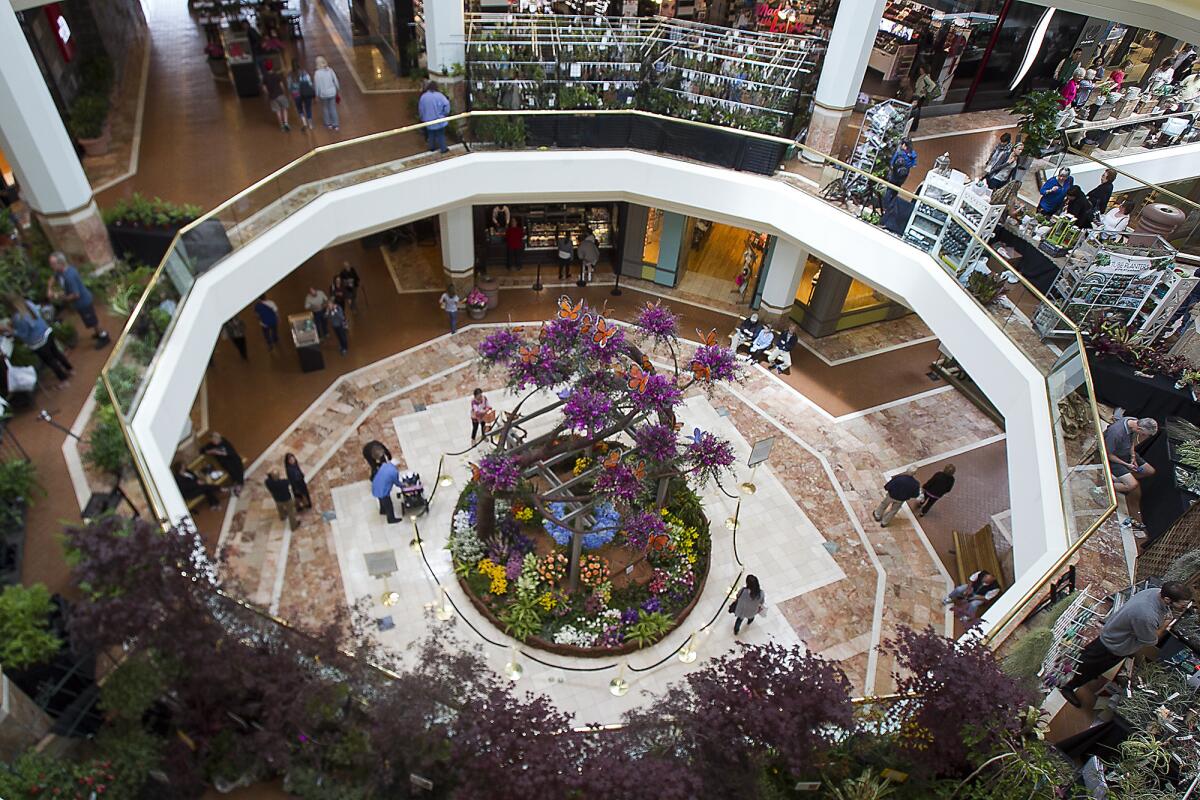 Guests view the center display titled Springtime at South Coast Plaza at the annual "At Home in the Garden" show at South Coast Plaza on Saturday.