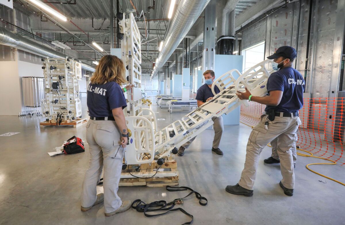 Workers from Cal-Mat dismantle one of beds on the 10th floor of Palomar Medical Center.