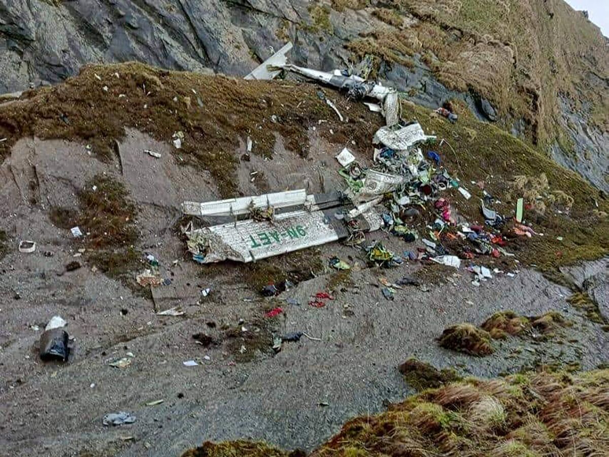 The wreckage of a plane carrying 22 people that disappeared in Nepal's mountains was found scattered on a mountainside.