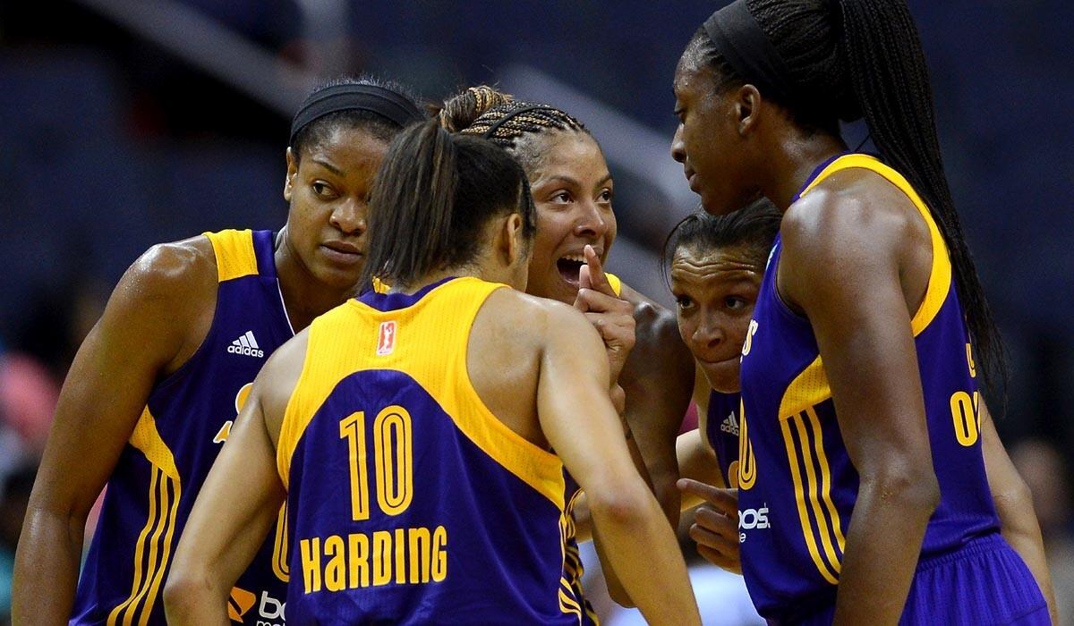 Sparks teammates, including Nneka Ogwumike, right, listen to forward Candace Parker during a game against the Mystics earlier this week.