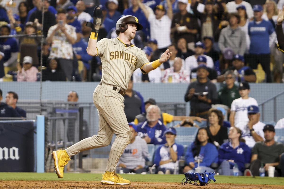 San Diego's Jake Cronenworth celebrates after scoring a run off a single by Jurickson Profar.