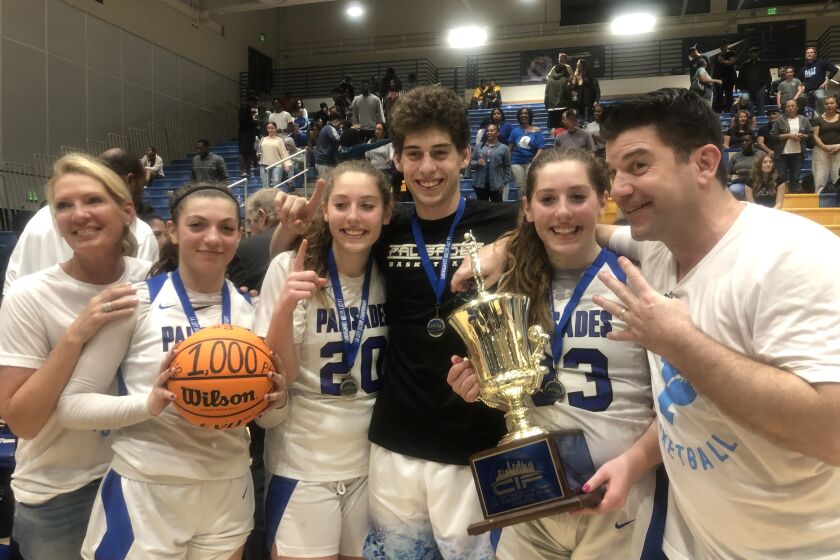 The Arnold family won four championship rings playing for Palisades on Saturday. Mother Stacey (left) celebrates championships for daughters Sammie, Elise, son Caden, daughter Taylor and husband Michael.