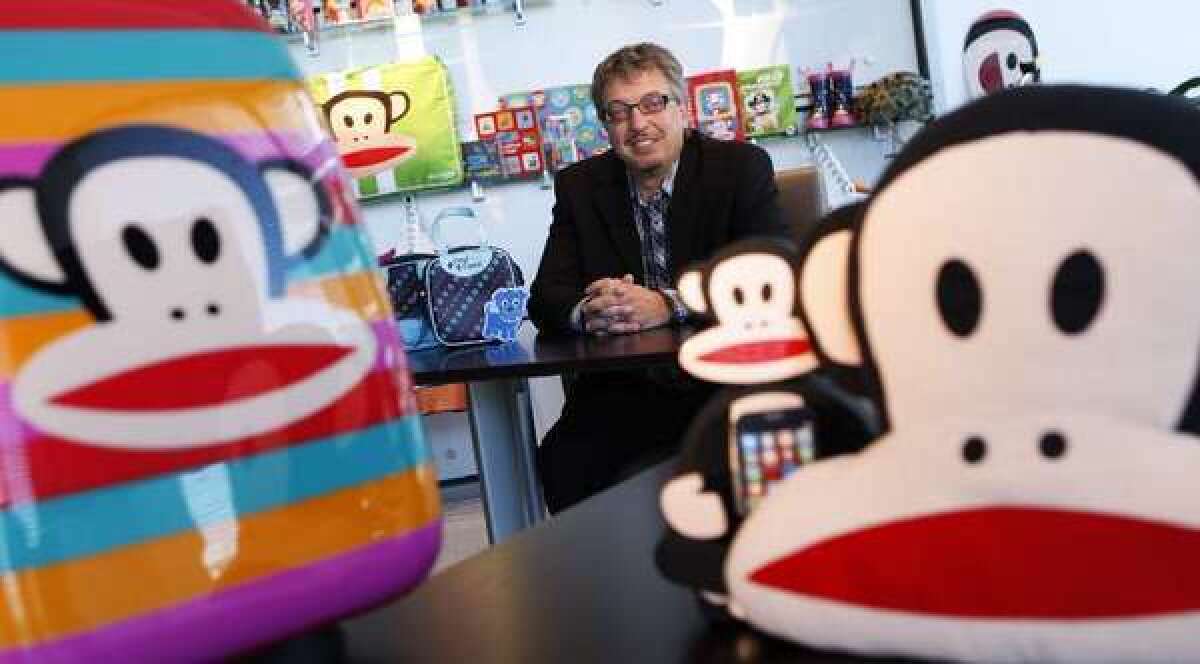 Paul Frank parent company Saban Brands President Elie Dekel surrounded by products featuring Paul Frank icon Julius the Monkey.