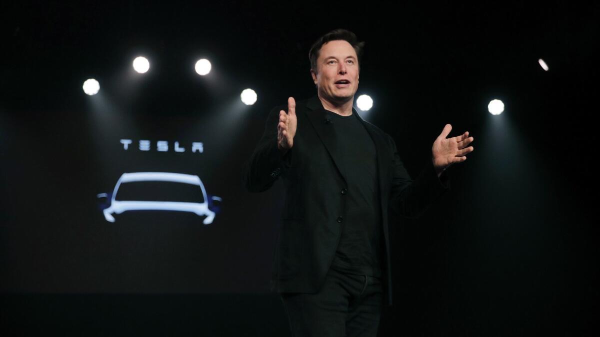 Tesla chief Elon Musk in March, showing off a crossover Model Y. It was unclear where the capital to build the car would come from as Musk embarked on a "hardcore" cost-cutting drive to meet current expenses.