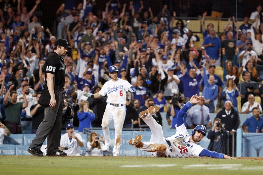 Dodgers' Cody Bellinger slides into home to score the winning run off an RBI infield single by Mookie Betts.