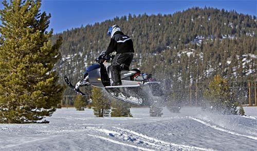 A snowmobiler gets air on a jump at Mammoth Lakes' Inyo National Forest, which features 100 miles of trails groomed for winter.