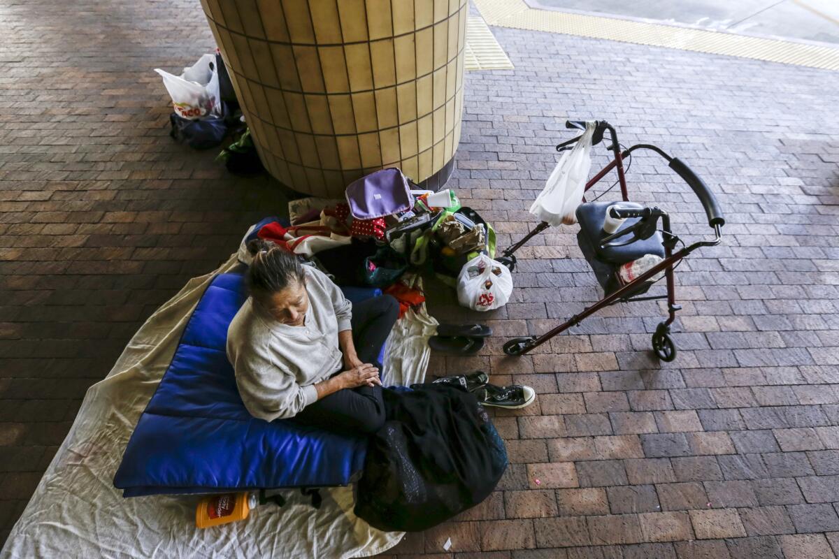 Denise Aken, 58, rests under the roof at the Courtyard, a downtown Santa Ana bus terminal, in 2016.