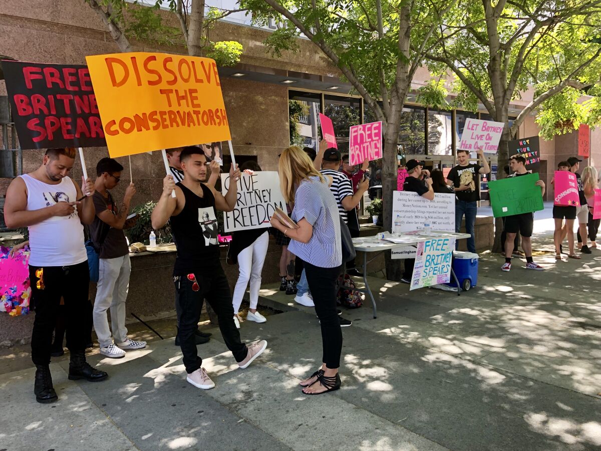 Fans hold signs protesting Britney Spears' conservatorship in downtown L.A.
