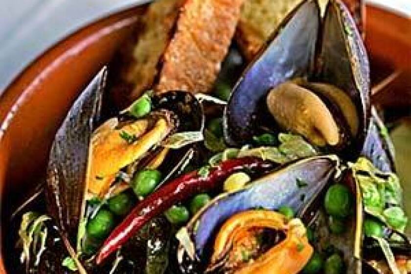 Mussels in white wine with new garlic and English peas.