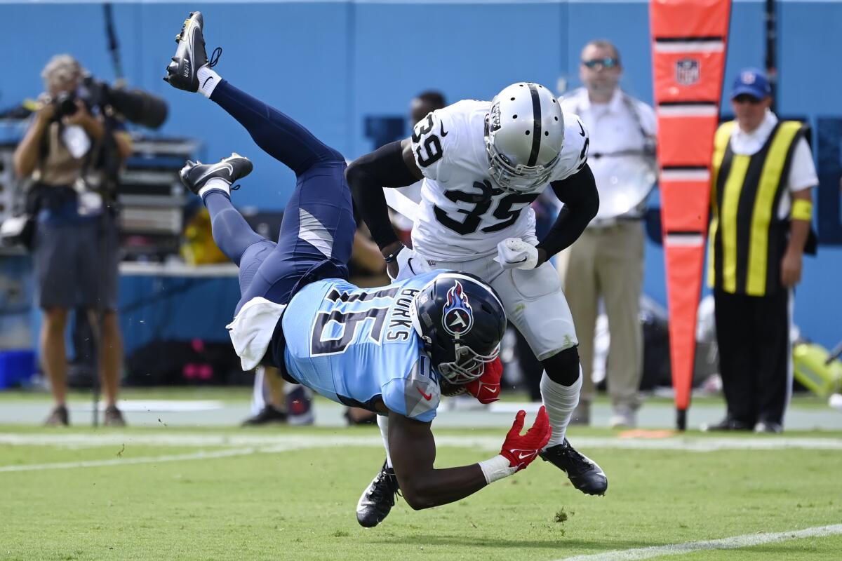 Tennessee Titans wide receiver Treylon Burks (16) is brought down short of the goal line by Las Vegas Raiders cornerback Nate Hobbs (39) in the first half of an NFL football game Sunday, Sept. 25, 2022, in Nashville, Tenn. (AP Photo/Mark Zaleski)