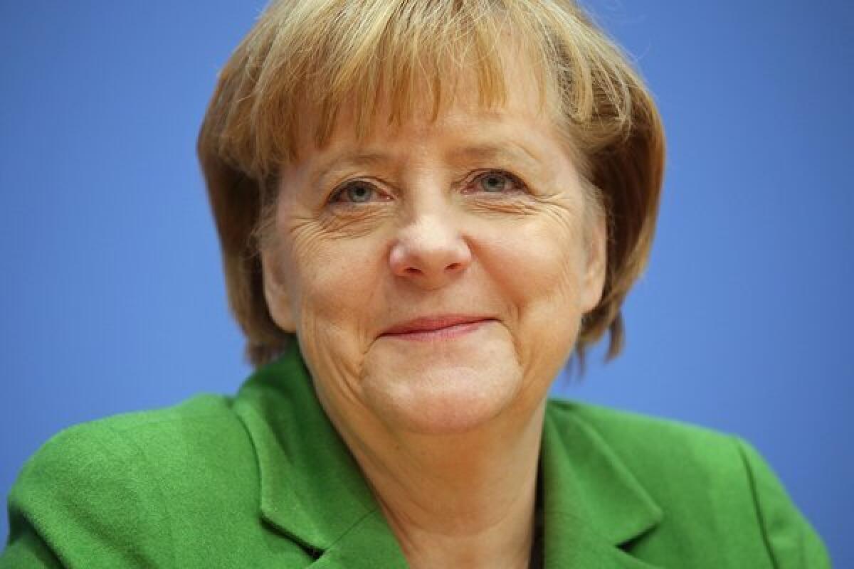 German Chancellor Angela Merkel talks to reporters after leaders of the main political parties agreed on a common agenda.