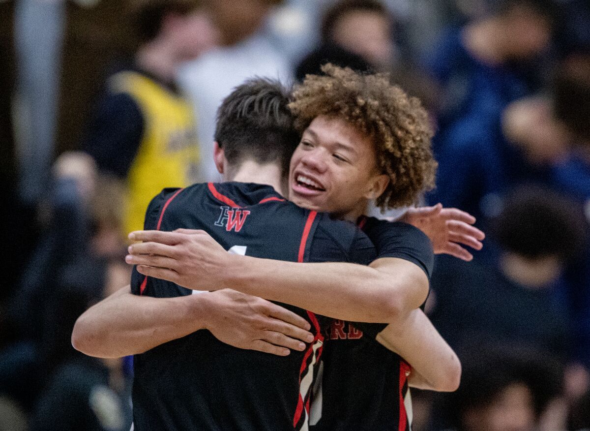 Harvard-Westlake High forward Brady Dunlap, left, embraces point guard Trent Perry after a victory.