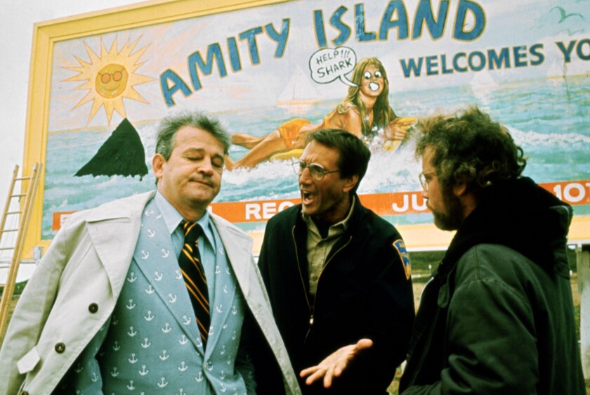 Murray Hamilton, left, Roy Scheider, and Richard Dreyfuss in front of a billboard in “Jaws” (1975).