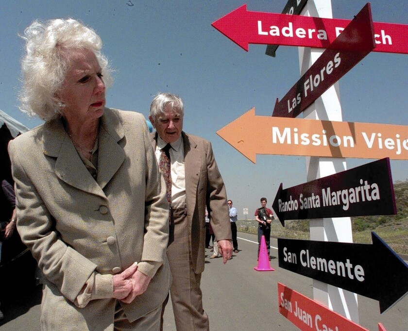 Alice O'Neill Avery checks a signpost pointing to places that were once part of her family’s ranch at a ceremony for the opening of a stretch of Antonio Parkway in Orange County in 1999.