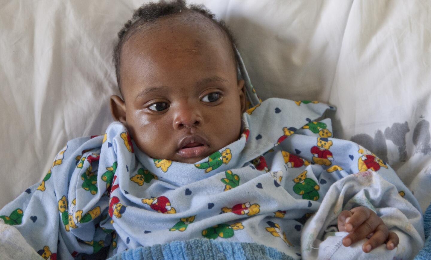 Dealeryn Saisi Wasike, the baby girl rescued early Tuesday from the rubble of a collapsed building, lies in a hospital bed at Kenyatta National Hospital in Nairobi.