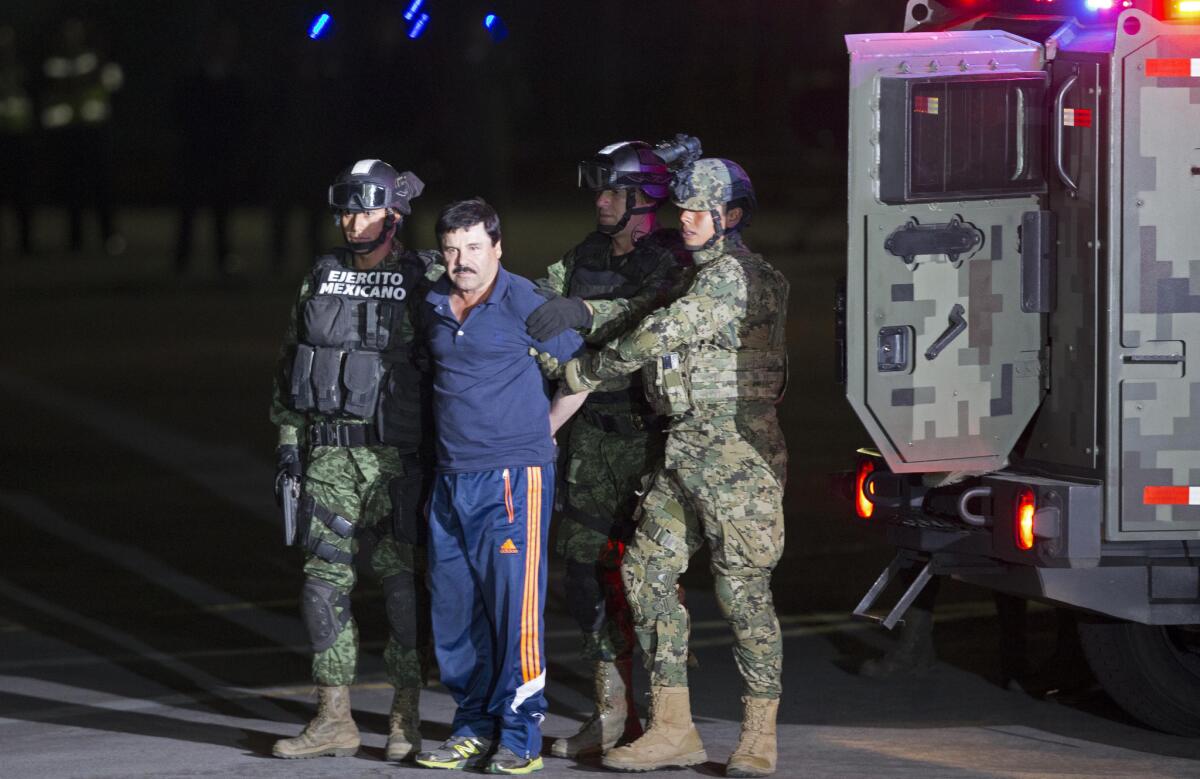 Mexican army soldiers escort drug lord, Joaquin "El Chapo" Guzman to a helicopter to be transported to a maximum security prison at MexicoGÇÖs Attorney GeneralGÇÖs hangar, in Mexico City, Friday, Jan. 8, 2016.