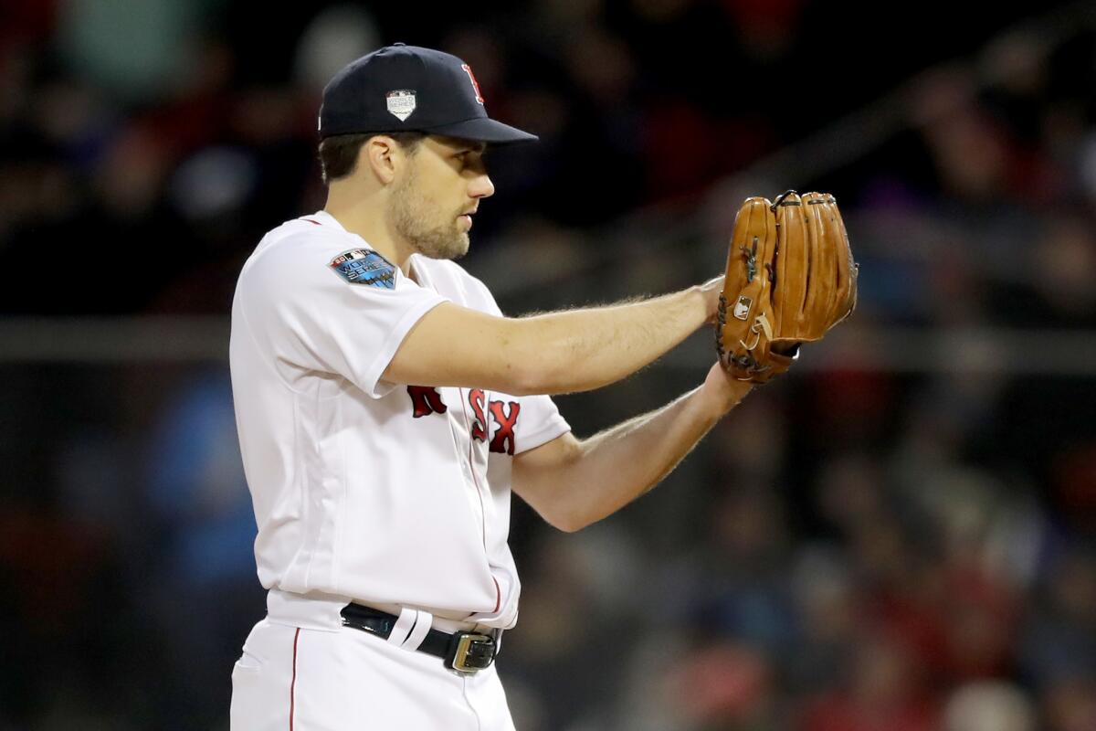Nathan Eovaldi checks the sign as he prepares to deliver a pitch against the Dodgers during Game 2 of the World Series.
