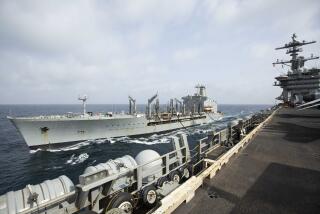 This handout photo from the U.S. Navy shows the Henry J. Kaiser-class fleet replenishment oiler USNS Big Horn sailing alongside the aircraft carrier USS Abraham Lincoln on Sept. 11, 2024, at an undisclosed location at sea in the Middle East. The Big Horn sustained damage in an incident which is under investigation, officials said Tuesday, Sept. 24, 2024. (U.S. Navy via AP)