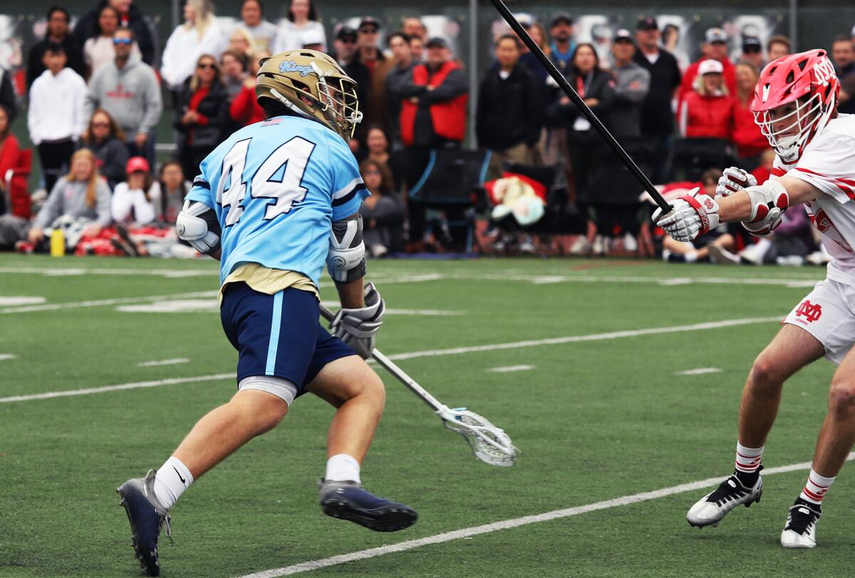Corona del Mar's Ty Caffarelli (44) passes at midfield against Mater Dei in a nonleague match on April 2.