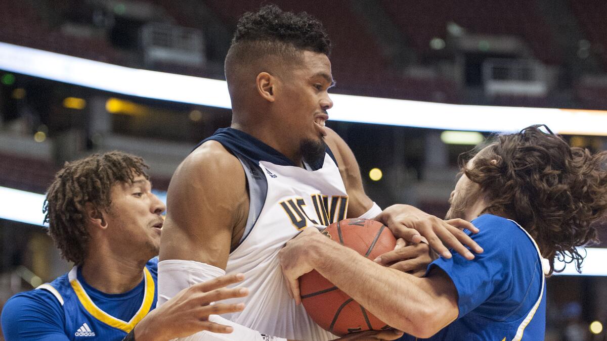 UC Irvine's Will Davis II, center, battles UC Riverside's Steven Thornton, left, and Nick Greninger for a rebound during a Big West Conference tournament victory Thursday.
